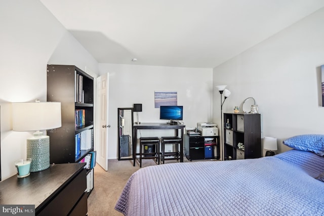 carpeted bedroom with an office area