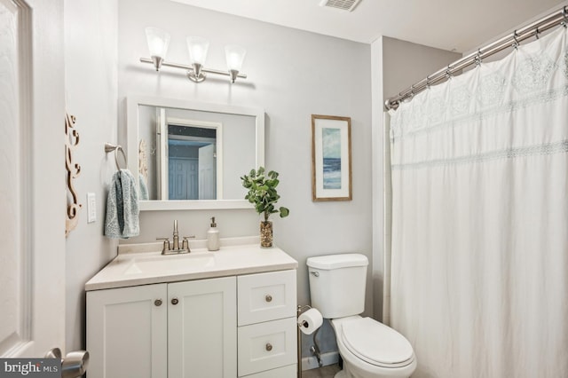 full bath with toilet and vanity
