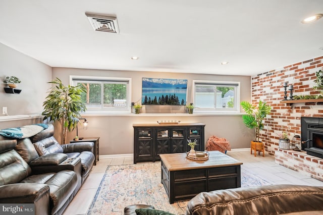 living room featuring tile patterned floors, a wood stove, recessed lighting, and baseboards