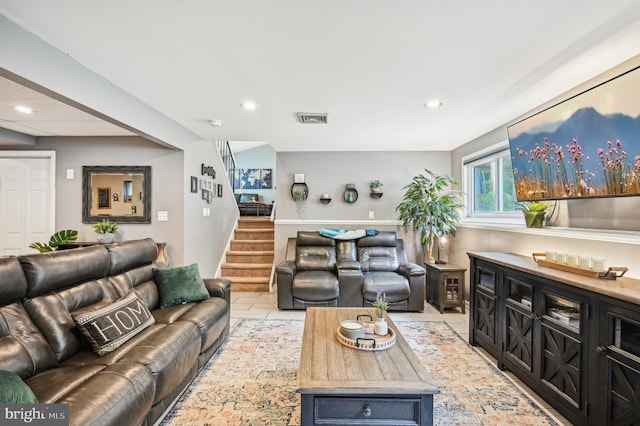 living area featuring stairway, recessed lighting, and light tile patterned floors