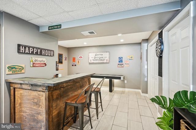 indoor dry bar featuring baseboards and recessed lighting