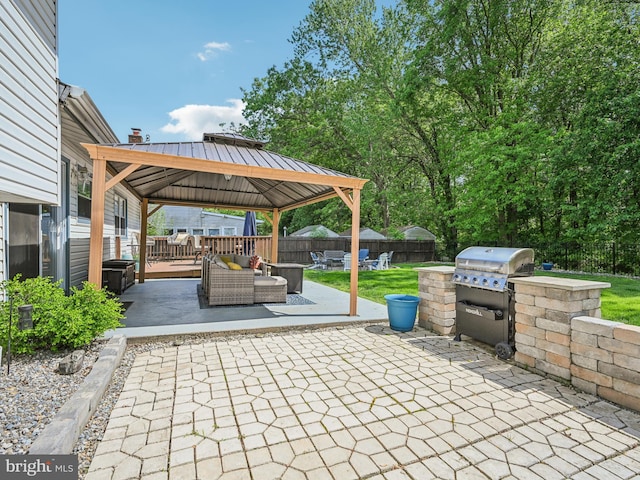 view of patio / terrace with a gazebo, area for grilling, a fenced backyard, an outdoor living space with a fire pit, and a grill