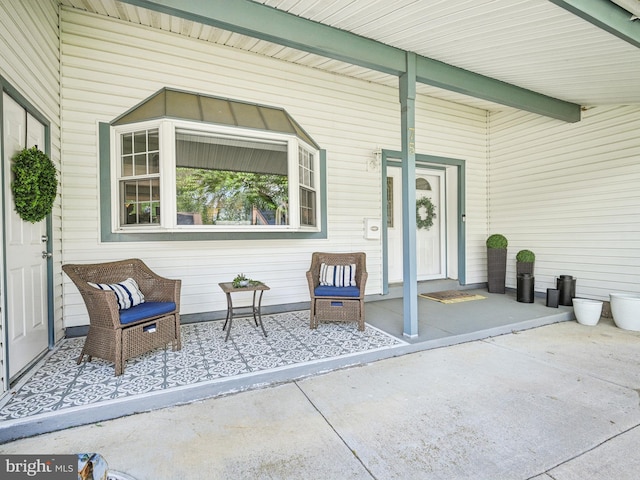 property entrance featuring a porch and a standing seam roof
