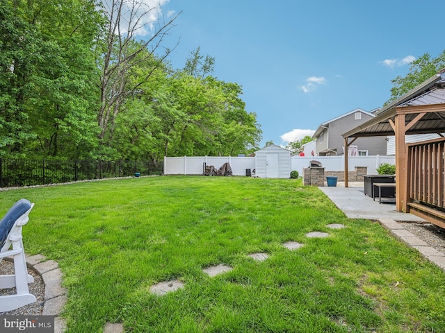 view of yard with a gazebo, a storage shed, a patio, and an outdoor structure