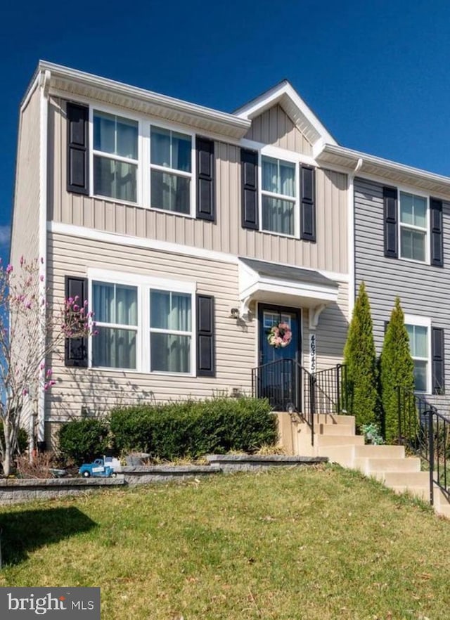 view of front facade featuring board and batten siding and a front yard