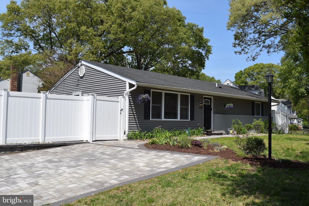 ranch-style home featuring fence, a patio area, and a front yard