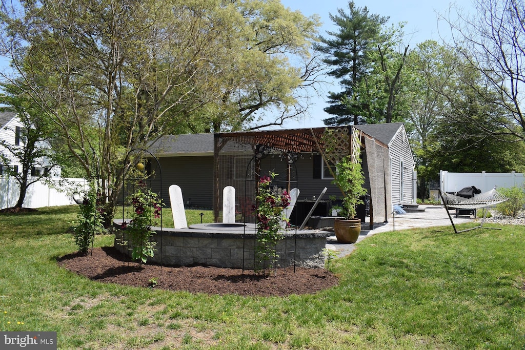 view of side of property with a patio, fence, and a yard