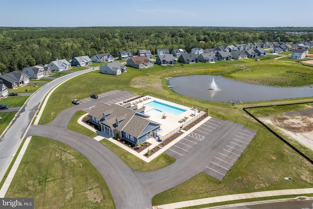 bird's eye view with a residential view, a water view, and a wooded view