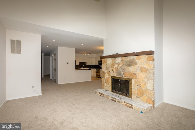 229 Keats Ct, Sicklerville, NJ 08081 - unfurnished living room with light carpet, a stone fireplace, and recessed lighting
