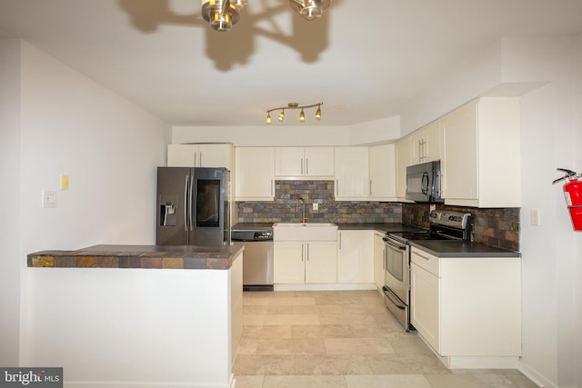 229 Keats Ct, Sicklerville, NJ 08081 - kitchen with appliances with stainless steel finishes, dark countertops, tasteful backsplash, white cabinets, and a peninsula