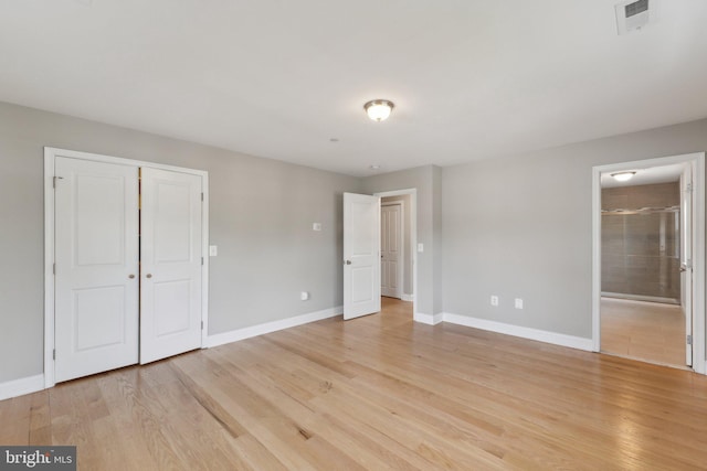 1600 Ballinger Ave, Landover, MD 20785 - unfurnished bedroom with baseboards, light wood-style flooring, a closet, and connected bathroom