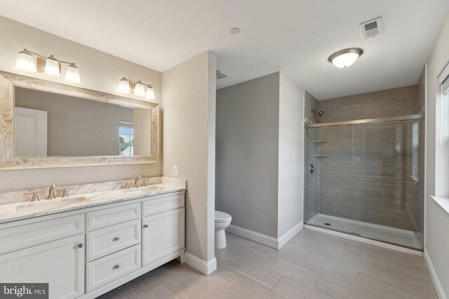 1600 Ballinger Ave, Landover, MD 20785 - bathroom featuring a shower stall, baseboards, double vanity, toilet, and wood finished floors