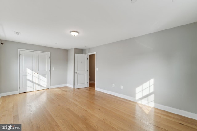 1600 Ballinger Ave, Landover, MD 20785 - unfurnished bedroom featuring baseboards, light wood-style floors, and a closet