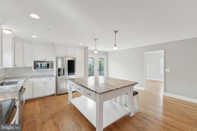 1600 Ballinger Ave, Landover, MD 20785 - kitchen with appliances with stainless steel finishes, a sink, french doors, light stone counters, and recessed lighting