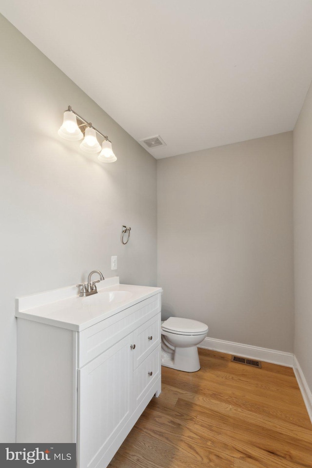1600 Ballinger Ave, Landover, MD 20785 - half bathroom with toilet, vanity, wood finished floors, and baseboards