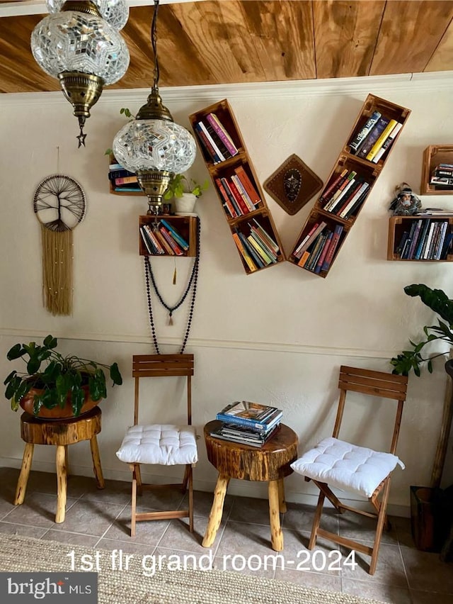 sitting room with wood ceiling, tile patterned floors, and baseboards