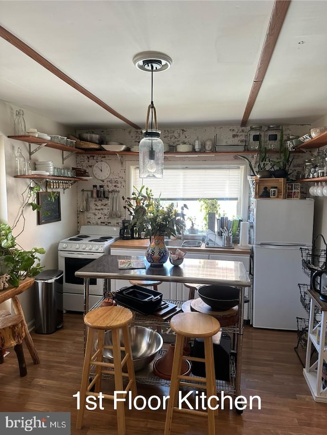 kitchen featuring white appliances and wood finished floors