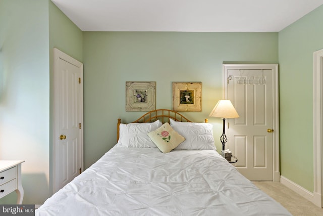 bedroom with baseboards and carpet
