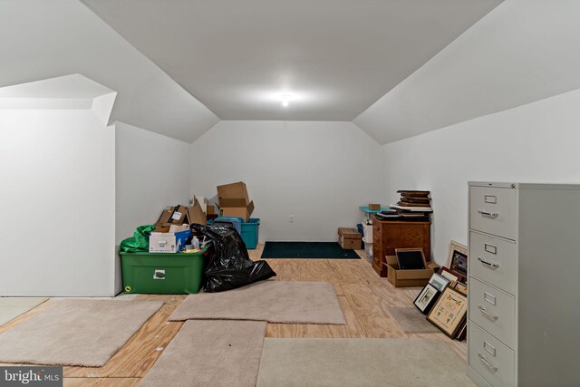 additional living space featuring vaulted ceiling and wood finished floors