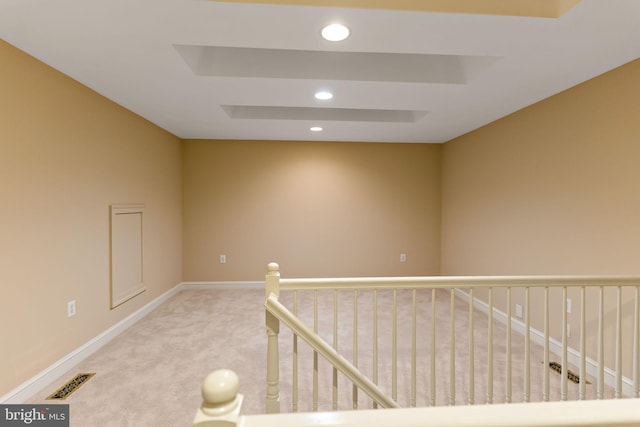 interior space featuring visible vents, light carpet, baseboards, recessed lighting, and an upstairs landing