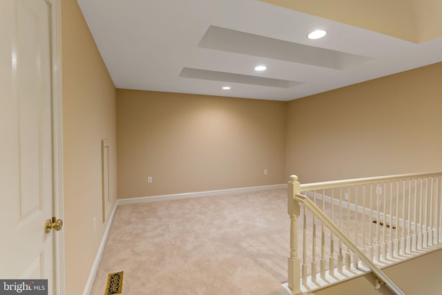 empty room with baseboards, light carpet, recessed lighting, and visible vents