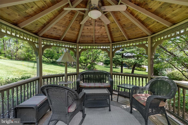 wooden terrace with a lawn, a gazebo, and ceiling fan