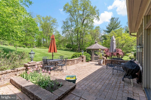 view of patio featuring outdoor dining area, a gazebo, and grilling area