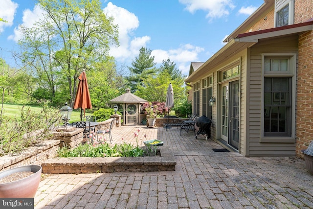 view of patio / terrace featuring outdoor dining area and a gazebo