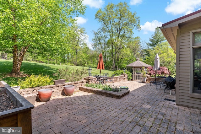 view of patio with a gazebo and outdoor dining area