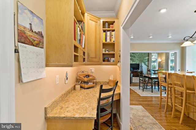 interior space with crown molding, open shelves, and wood finished floors