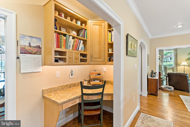 office featuring baseboards, ornamental molding, and light wood-type flooring