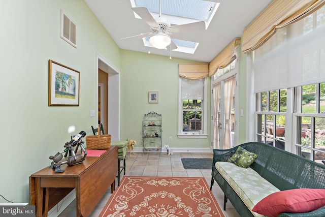 sunroom / solarium with baseboards, tile patterned flooring, lofted ceiling with skylight, and visible vents
