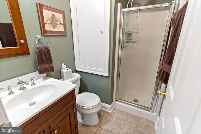 full bathroom featuring vanity, tile patterned floors, toilet, and a shower stall