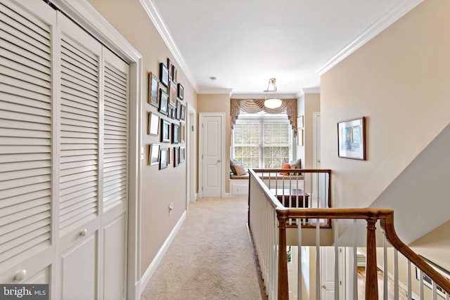 hallway with baseboards, ornamental molding, an upstairs landing, and light colored carpet
