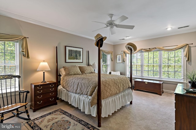 carpeted bedroom featuring visible vents, ornamental molding, baseboards, and multiple windows