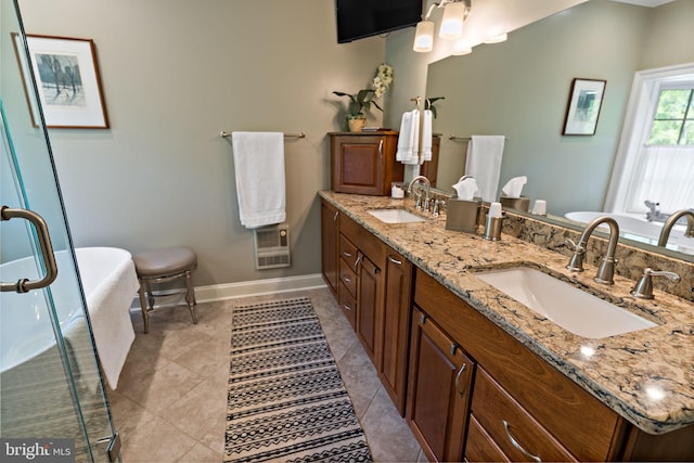 full bathroom featuring baseboards, a sink, double vanity, and a soaking tub