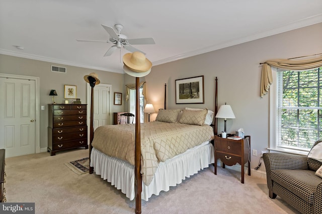 bedroom with crown molding, ceiling fan, light carpet, and visible vents