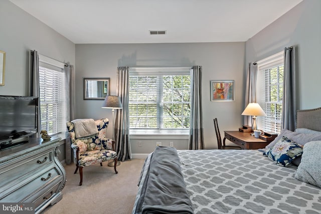 carpeted bedroom with visible vents and baseboards