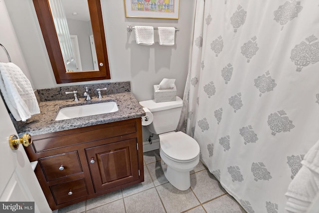 bathroom featuring toilet, a shower with curtain, tile patterned flooring, and vanity