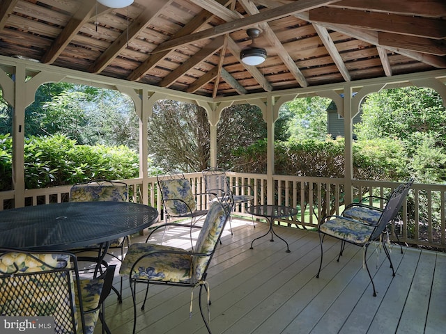 wooden deck featuring a gazebo and outdoor dining area
