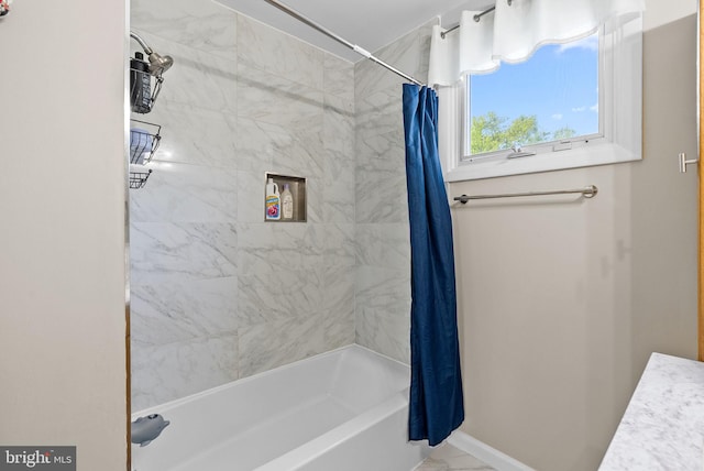 full bath featuring baseboards and shower / bath combination with curtain