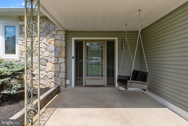 doorway to property with stone siding
