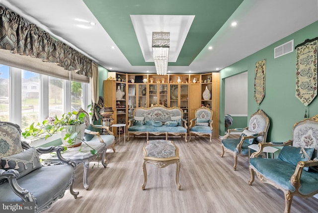 sitting room with recessed lighting, visible vents, and wood finished floors