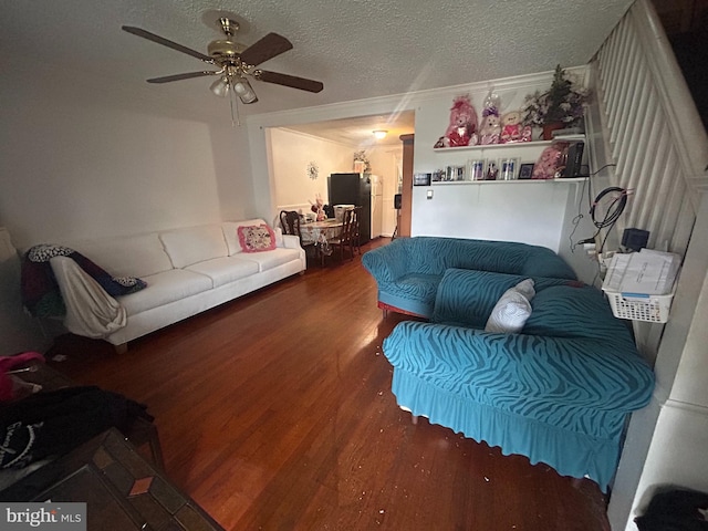 421 52nd St, Baltimore, MD 21224 - living room with wood finished floors, ceiling fan, and a textured ceiling