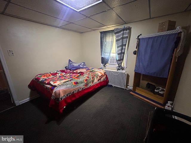 421 52nd St, Baltimore, MD 21224 - bedroom with radiator heating unit, a paneled ceiling, and dark colored carpet