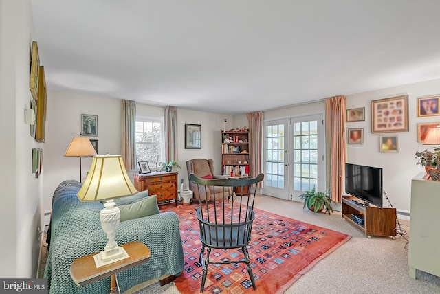 carpeted living area with french doors and a wealth of natural light