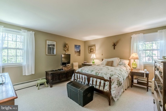 bedroom with multiple windows, carpet, and a baseboard radiator