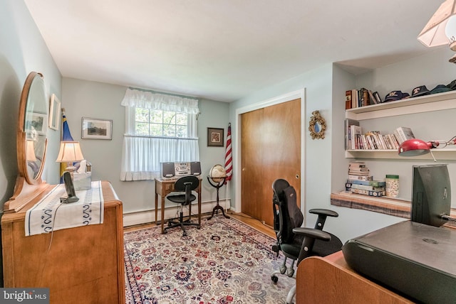 home office with wood finished floors and a baseboard radiator
