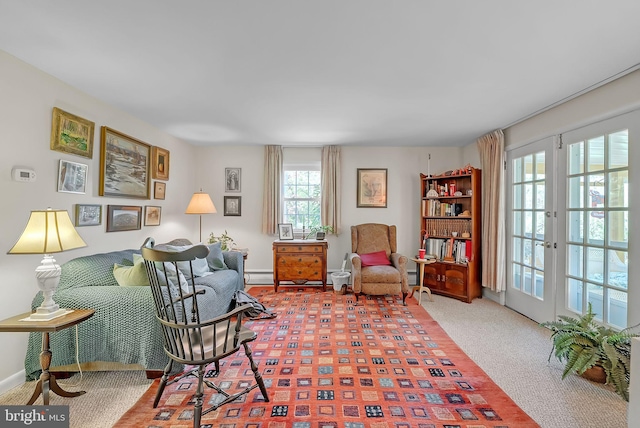 sitting room featuring baseboards, french doors, and a baseboard heating unit