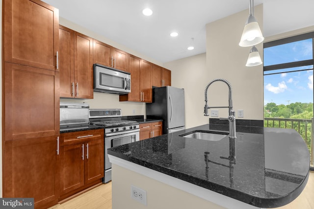 444 W Broad St Unit 407, Falls Church, VA 22046 - kitchen featuring appliances with stainless steel finishes, a sink, dark stone counters, light wood-style floors, and recessed lighting